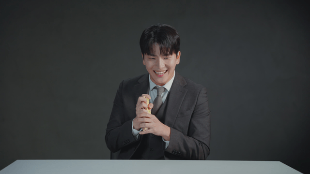 Man in a suit joyfully holding money