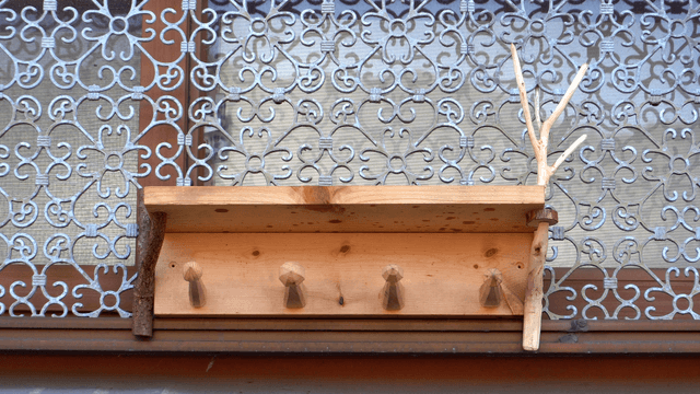 Wooden shelf above decorated window