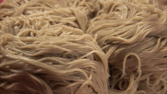 Freshly cooked buckwheat noodles in a strainer