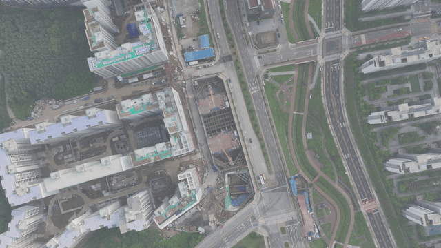 Aerial view of a city with roads and greenery