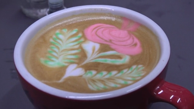 Latte art with colorful floral design