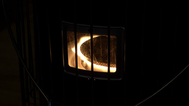 Glowing heater in a dark room