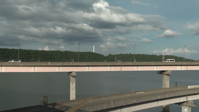 Cars crossing bridge over river