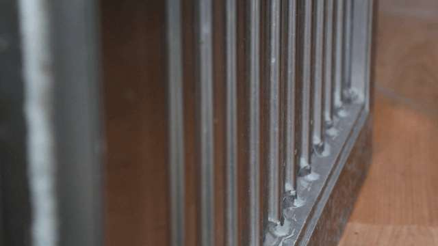 Close-up of a metal railing indoors