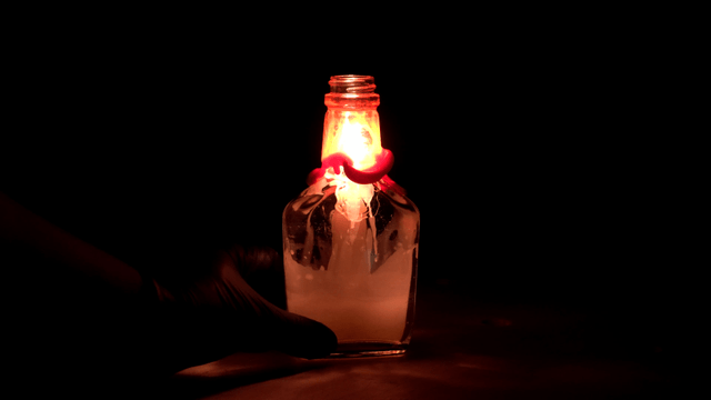 Candle burning inside a glass bottle
