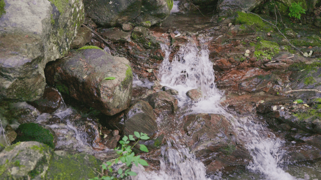 Clear valley stream flowing over rocks