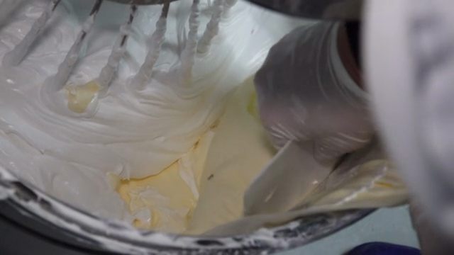 Adding butter in a large dough mixer
