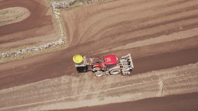 Tractor working on a large farmland