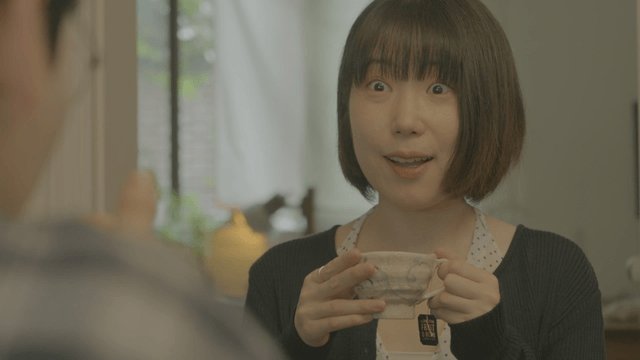 Short-haired woman enjoying tea at cafe
