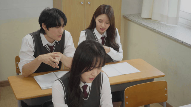 Student bowing head in frustration after classmates’ teasing