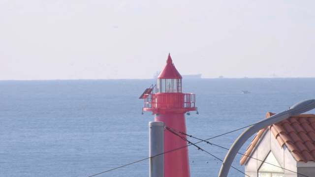 Red lighthouse by the sea