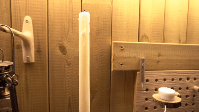 Candles on a wooden shelf in the workshop