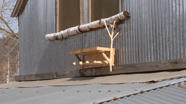 Wooden shelf stand placed under a rural house window