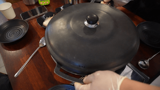 Wide pot placed on tabletop gas stove