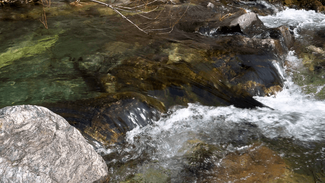Clear valley stream flowing over rocks