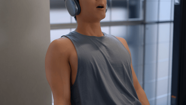 Man working out with headphones at the gym