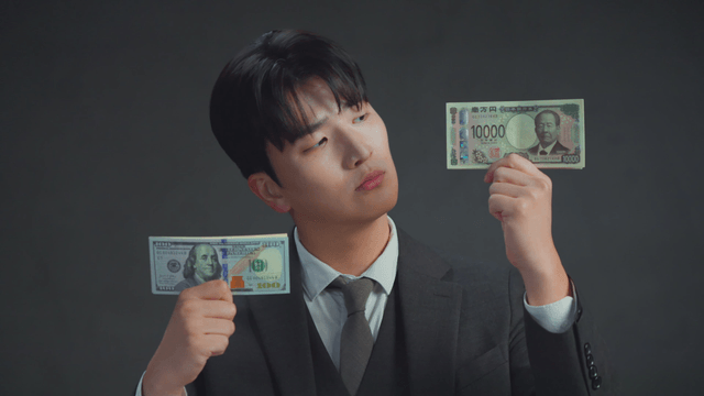 Man smiling at the US dollar bills in his hand