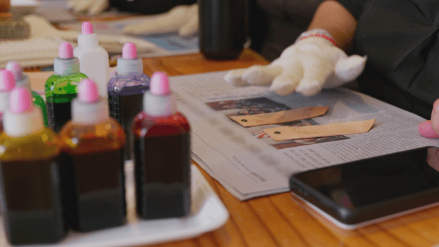 Person crafting with colorful dyes indoors