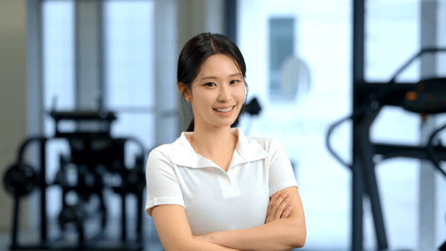 Confident woman smiling forward in gym