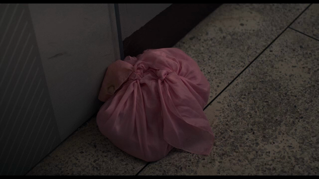 Pink cloth bundle on a tiled floor