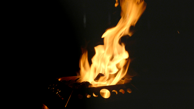 Campfire burning brightly in the dark