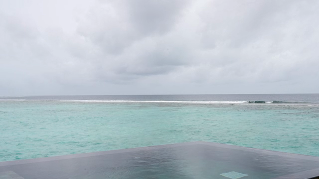 A calm ocean under a cloudy sky