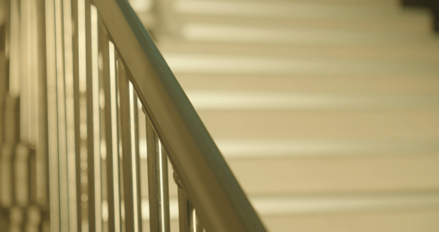 Two schoolgirls running down holding the school stair railing