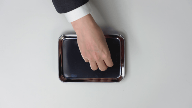 Hand picking up Korean won and Bitcoin from a tray