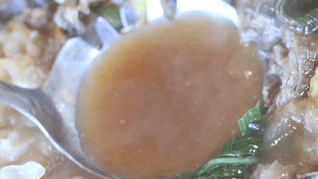 Hot pot broth scooped with a ladle