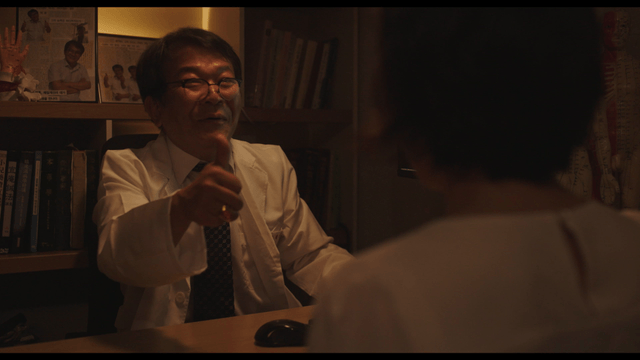 Happy doctor and patient handing red money envelope