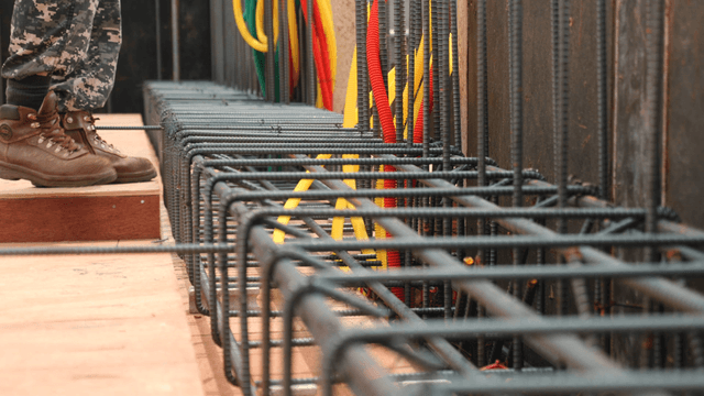 Worker assembling rebar at a construction site