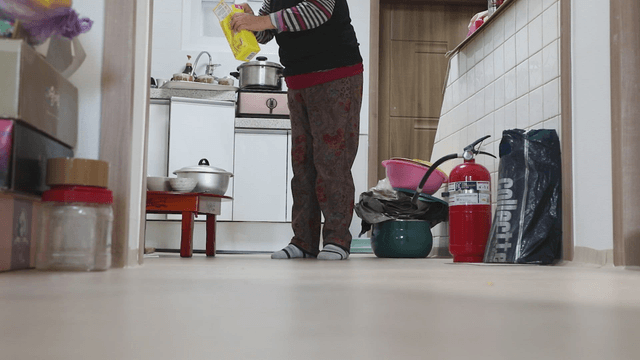 Elderly person in a kitchen preparing mix coffee