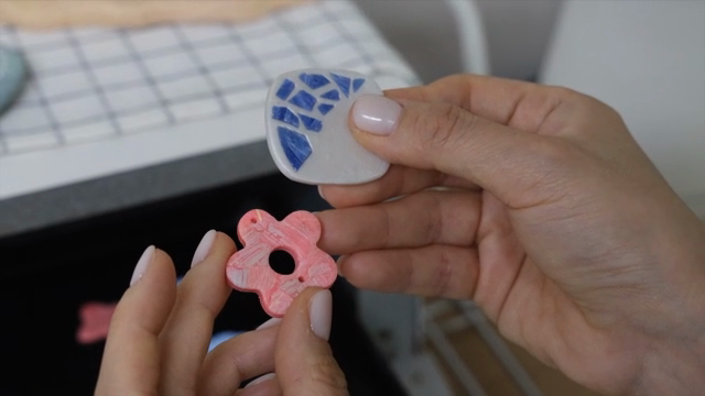 Hands holding colorful handmade crafts