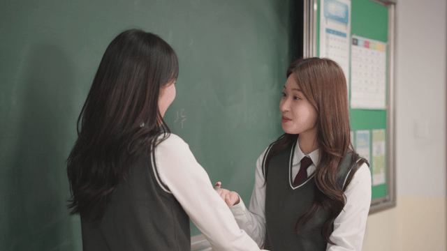 Students playing and doodling on the chalkboard