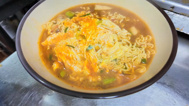 Ramyeon wirh egg being transferred into a bowl
