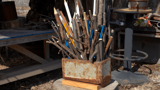 Wooden pencil carvings placed in a rusty metal container