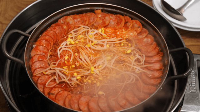 Korean army stew with sausages boiling