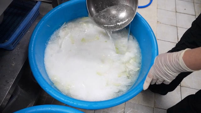 Preparing vegetables in a blue basin