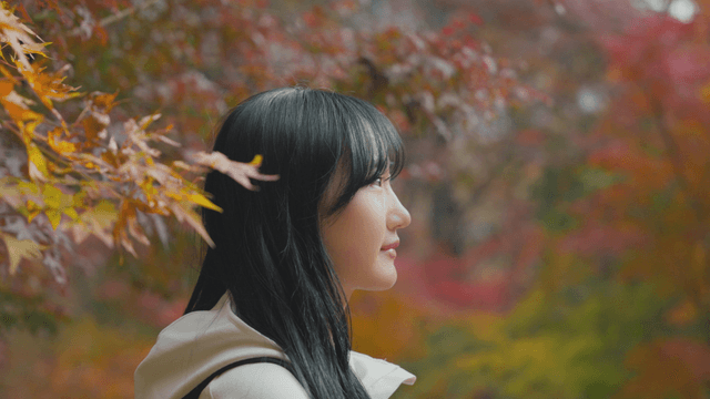 Young woman enjoying autumn foliage