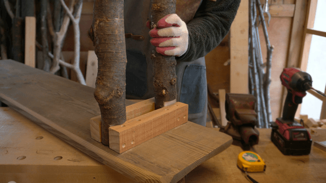 Woodcraft artisan assembling wooden materials in workshop