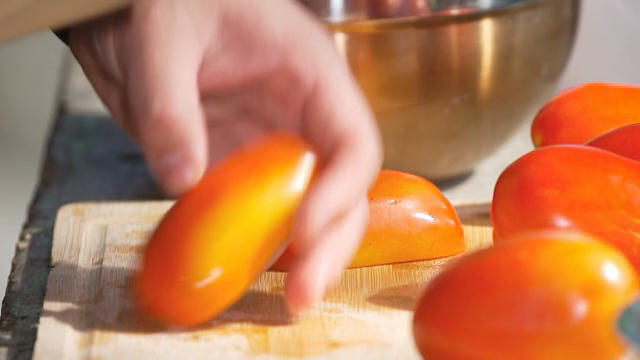 Slicing fresh tomatoes on a cutting board