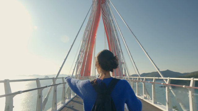 Woman walking on a scenic bridge