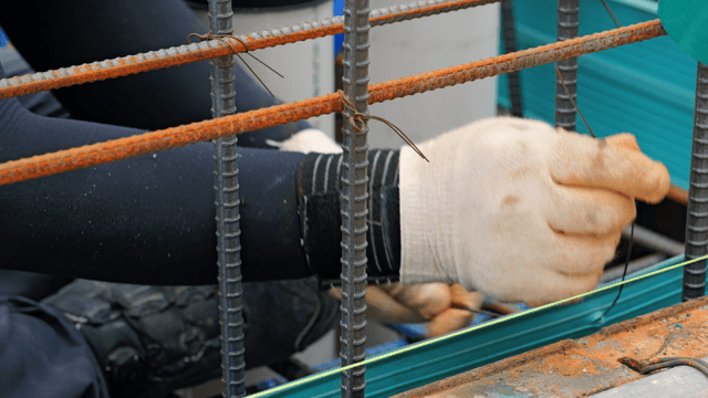 Worker tying rebar at a construction site