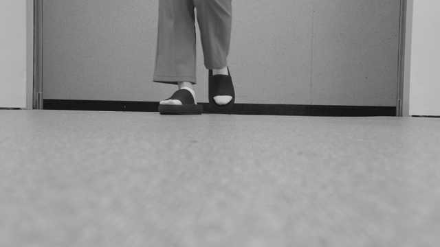 Person walking in a hallway indoors