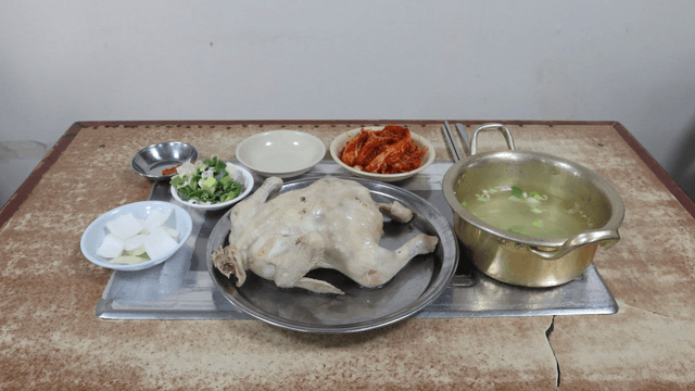 Table set with chicken soup and side dishes