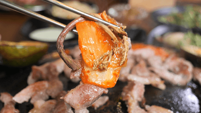 Grilled pork with kimchi on a grill