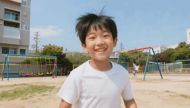 Elementary school children playing happily at the playground