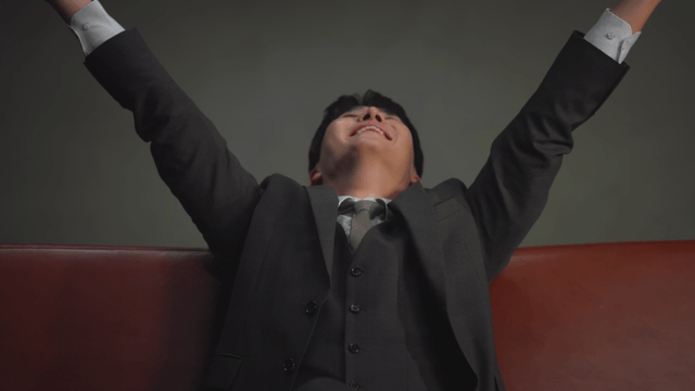 Man sitting on a sofa throwing money