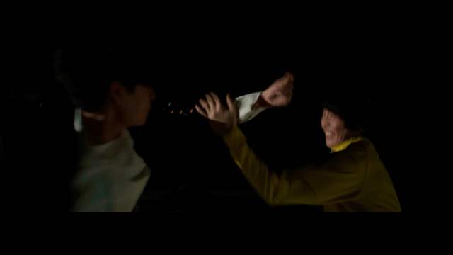 Nighttime martial arts scene with two men