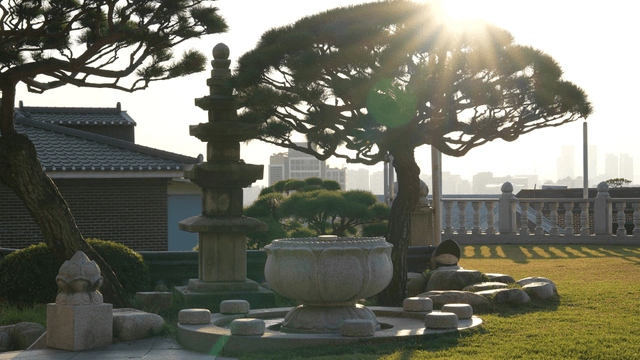 Sunlit garden with a stone pagoda